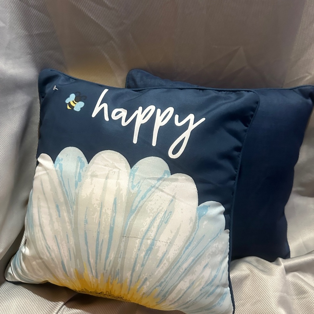 2 blue happy pillows in  outdoor